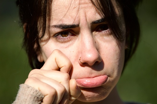 Sad girl, crying facial expression outdoor