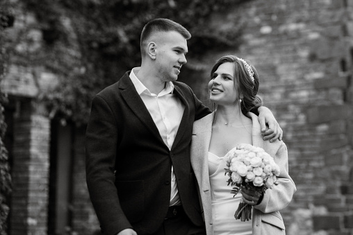 portrait of a young couple of bride and groom on their wedding day in a country cottage