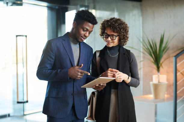 istock Young confident African American manager pointing at tablet screen 1487017089