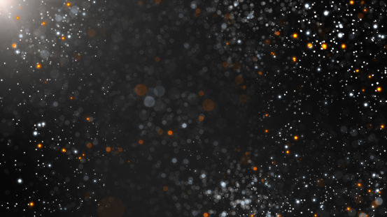 White orange flicker dust particle flow on black background.