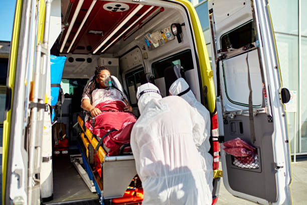 istock Emergency services team removing woman from ambulance 1487018332