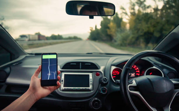 istock Holds a phone with a navigator in the car 1487018335