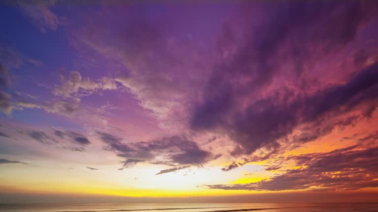 Dramatic dark clouds background,Beautiful 4K Time lapse of Majestic sunrise or sunset clouds sky landscape,Amazing light of nature cloudscape sky and Clouds moving away rolling,Dark cloud timelapse