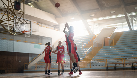 Professional female basketball players having training on indoor court. Team sport and healthy lifestyle concept.