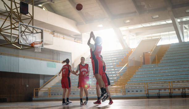Professional Female Basketball Players Training In Indoor Court stock photo