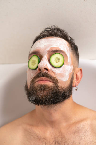 istock man with cucumber and face mask relaxing in bath at home 1487021316
