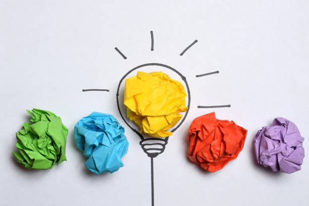 istock Creative thinking ideas and innovation concept. Paper scrap ball yellow colour with light bulb symbol 1487022327