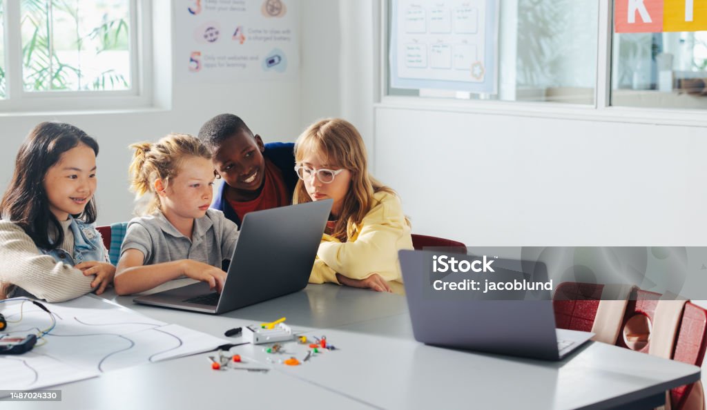 Group Of School Kids Learn To Code And Program Robots In A ...