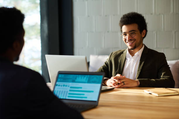 istock Happy young multi-ethnic businessman looking at colleague 1487024417