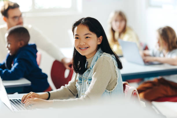 istock Happy Asian girl enjoying a coding class, using a laptop to engage in the lesson 1487024479