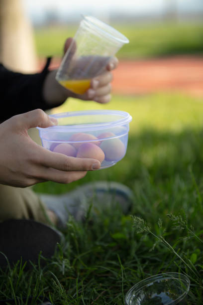 istock Young man is holding a plastic cup on the outside. 1487024851