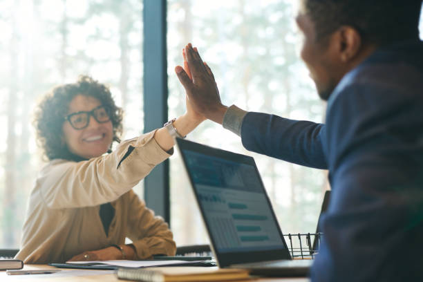 istock Focus on hands of two successful colleagues giving each other high-five 1487025015