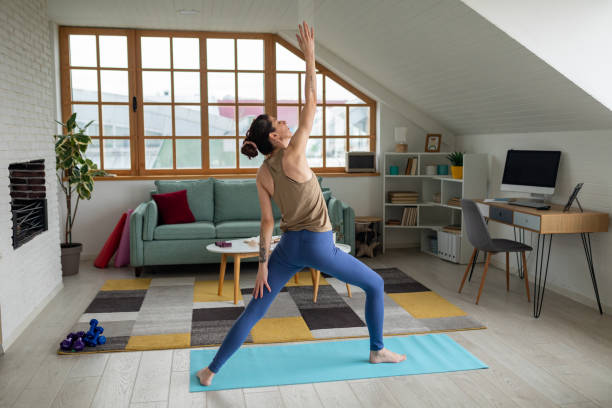 istock Woman doing yoga at home 1487026447