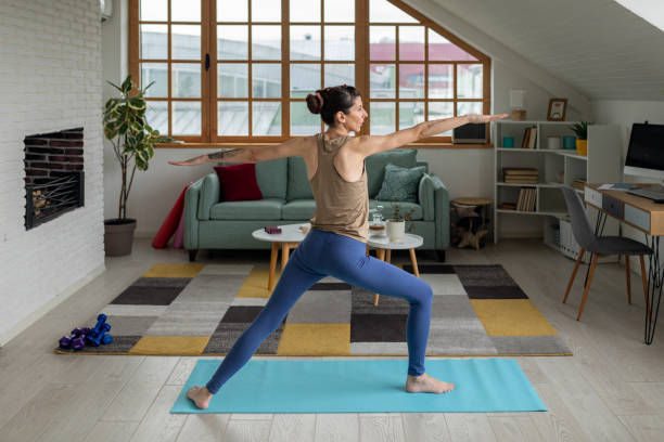 istock Woman doing yoga at home 1487026552