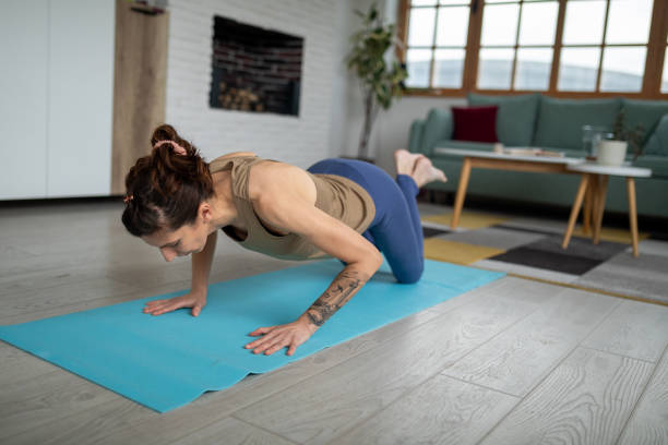 istock Woman doing yoga at home 1487026873