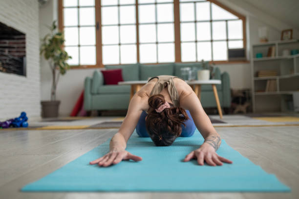 istock Woman doing yoga at home 1487026875
