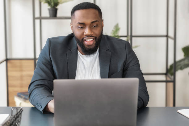 istock business man works having online conference consulting client or communicates with employees sitting in office 1487028401