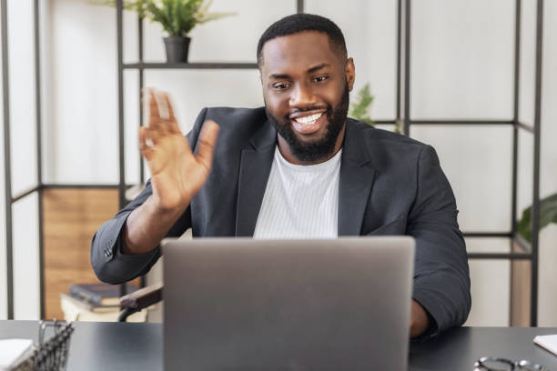 istock business man working having online conference showing greets sign, consulting client or communicates with employees 1487028456
