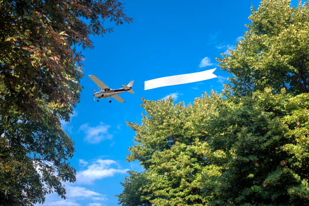 istock Airplane with banner to clear sky 1487028517