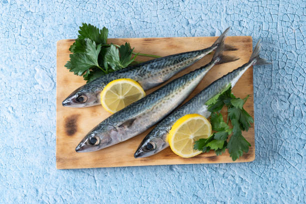 istock Raw mackerel fish salt around on blue background 1487028841