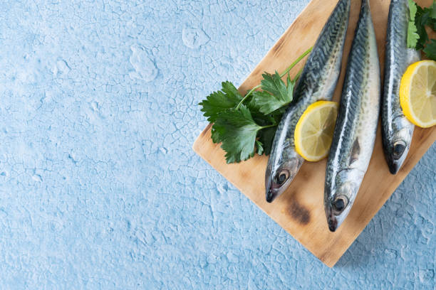 istock Raw mackerel fish salt around on blue background 1487028862