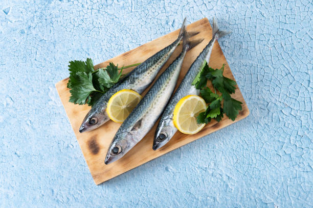istock Raw mackerel fish salt around on blue background 1487028882