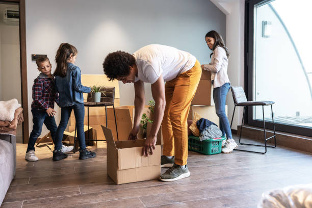 istock Mixed race family moving into their new home. 1487035321