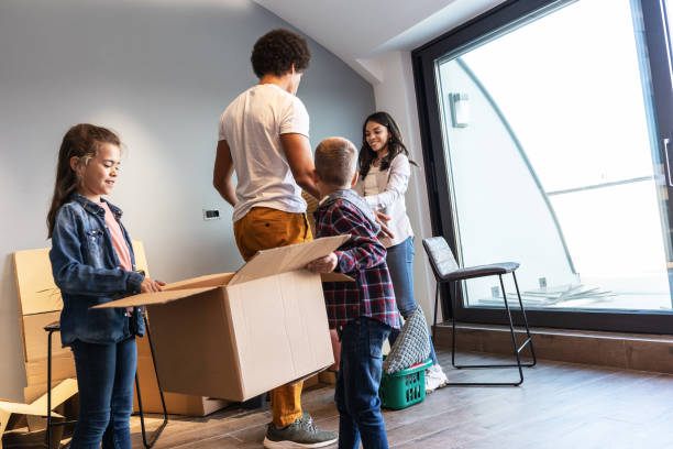 istock Mixed race family moving into their new home. 1487035355
