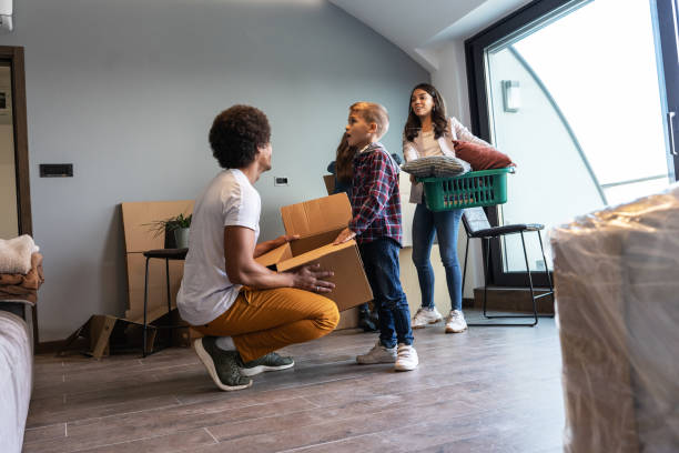 istock Mixed race family moving into their new home. 1487035377