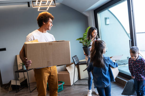 istock Mixed race family moving into their new home. 1487035421