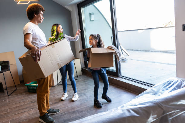 istock Mixed race family moving into their new home. 1487035455