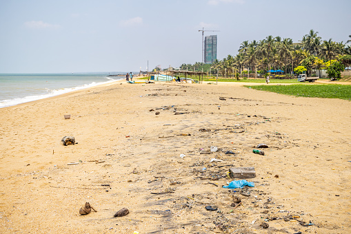 Negombo, Western Province, Sri Lanka - March 9th 2023:  Plastic and other debris on the beach