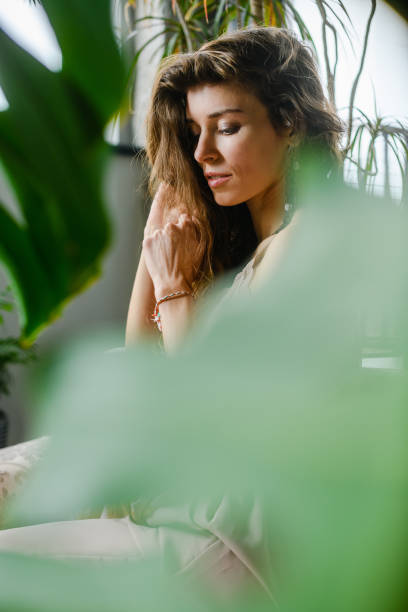 istock Woman sit in cozy home with plants 1487038026