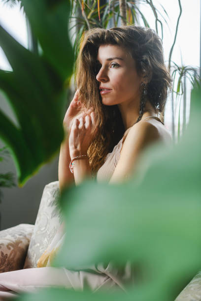 istock Woman sit in cozy home with plants 1487038027