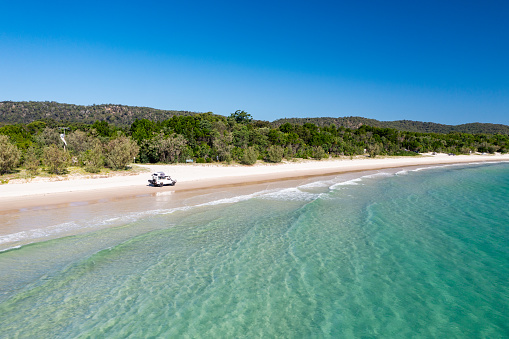 4WD off-road vehicle driving on beach, Moreton Island, Queensland, Australia