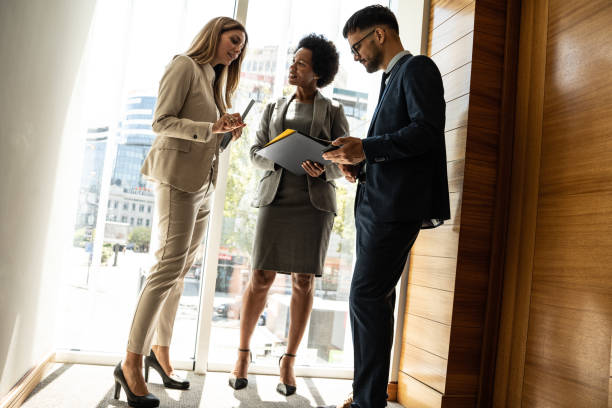 istock Group of businesspeople taking a break in office lobby. 1487039185