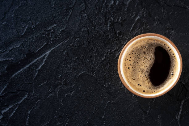 istock Coffee cup, top shot on a black slate background with a place for text 1487039229