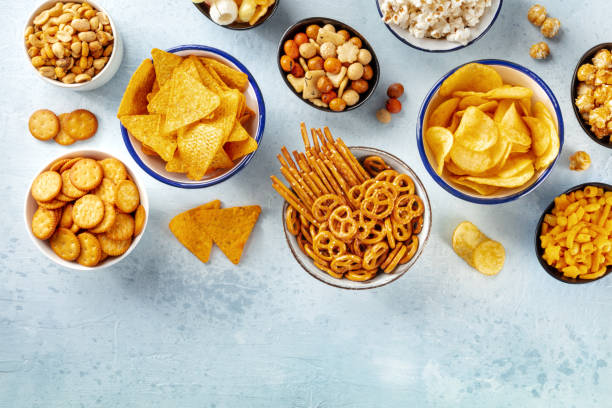 istock Salty snacks, party mix, overhead flat lay shot with copy space. An assortment 1487039281
