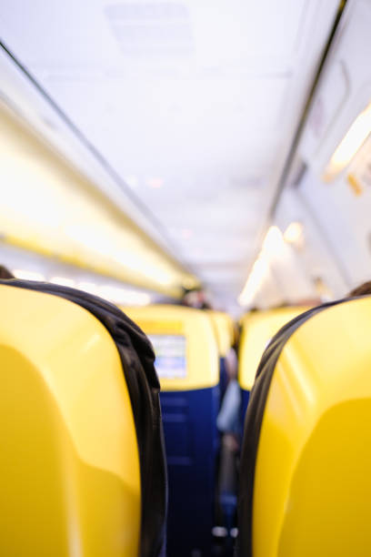 istock Vertical picture of Low Cost Airline Cabin with Unrecognizable Passengers 1487040003