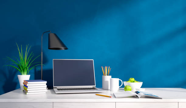 istock Modern home office desk against blue wall 1487041881