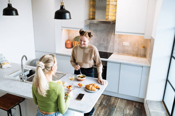 istock Two friends enjoying preparing dinner at home 1487042094