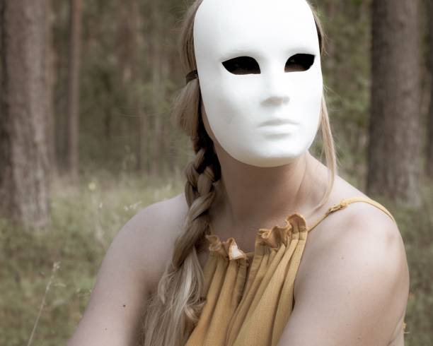 Theatrical white face mask on black background