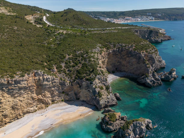 istock Cliff and rocks on the beach in Sesimbra 1487044696