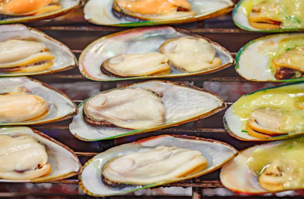 istock Green chilean mussels fried on grill in open flaps, selective focus 1487046078