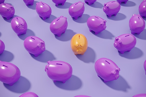 An orange colored piggy bank standing out from the crowd.(3d render)