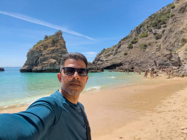 istock Tourist taking a selfie on the beach in Sesimbra 1487054980