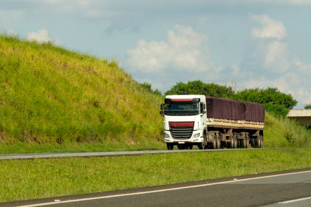 Photo of a white semi-truck in a highway,