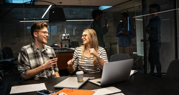 istock Two engineers and programmers sitting in the office and working on a new startup project. Discuss business strategy. 1487056763