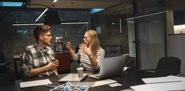 Two engineers and programmers sitting in the office and working on a new startup project. Discuss business strategy.