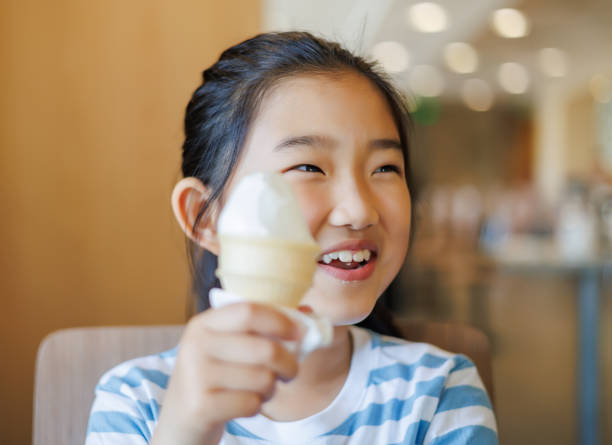 istock Little Girl Eating Ice Cream 1487056986